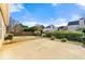 Backyard patio featuring a manicured lawn, decorative hedges, and privacy fence under a bright, cloudy sky at 3296 Quincey Xing, Conyers, GA 30013