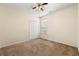 Simple bedroom with neutral carpet, window, and white closet doors at 3296 Quincey Xing, Conyers, GA 30013