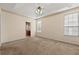 Carpeted bedroom with a tray ceiling, two windows and a bathroom at 3296 Quincey Xing, Conyers, GA 30013