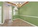 Dining room featuring light green walls, a chandelier, and tile flooring at 3296 Quincey Xing, Conyers, GA 30013