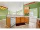 The view of this kitchen features light-colored cabinets, tile flooring, and view to other rooms at 3296 Quincey Xing, Conyers, GA 30013