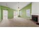 Large carpeted living room with light green walls, fireplace, and plenty of natural light at 3296 Quincey Xing, Conyers, GA 30013