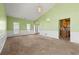 Bright living room featuring neutral carpet, and a view into the entry and kitchen at 3296 Quincey Xing, Conyers, GA 30013