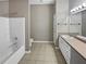 Bathroom featuring a combination shower and bathtub, sink and toilet at 1394 Orchard Park Dr, Stone Mountain, GA 30083