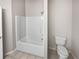Small bathroom features a shower-tub combo and toilet at 1394 Orchard Park Dr, Stone Mountain, GA 30083