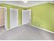 Bright, carpeted bedroom with two entry doors and a walk-in closet at 1394 Orchard Park Dr, Stone Mountain, GA 30083