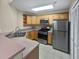 Well-lit kitchen with stainless steel appliances and wooden cabinets at 1394 Orchard Park Dr, Stone Mountain, GA 30083