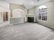 Spacious living area with fireplace, large window, and neutral carpeting at 1394 Orchard Park Dr, Stone Mountain, GA 30083