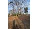 Image showing a backyard with sparse grass, trees, and outbuildings at 1413 Lanier Ne Pl, Atlanta, GA 30306