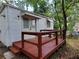 Charming home featuring a cozy deck and quaint facade, nestled amongst mature trees, offering peaceful outdoor enjoyment at 1413 Lanier Ne Pl, Atlanta, GA 30306