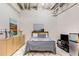 Basement bedroom features a full bed, small refrigerator, modern furniture, and neutral decor at 500 Means Nw St # F, Atlanta, GA 30318