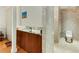 Bathroom featuring a modern vanity with stone countertops, complemented by tiled walls and a toilet at 500 Means Nw St # F, Atlanta, GA 30318
