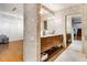 Modern bathroom with double sink vanity, tile walls, granite countertop, and access to the hallway at 500 Means Nw St # F, Atlanta, GA 30318