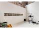 A home gym features exposed brick, white epoxy flooring, weight lifting equipment, and vinyl record storage at 500 Means Nw St # F, Atlanta, GA 30318