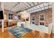 Upstairs open living room with lots of natural light, hardwood flooring and brick accent wall at 500 Means Nw St # F, Atlanta, GA 30318