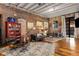 Cozy living room boasts exposed brick, hardwood floors, a red bookshelf, and modern furnishings at 500 Means Nw St # F, Atlanta, GA 30318