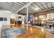 Open-concept living space with exposed brick, wooden beams, and hardwood floors throughout at 500 Means Nw St # F, Atlanta, GA 30318