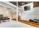 Open-concept living space featuring exposed beams, hardwood floors, and modern decor and work space at 500 Means Nw St # F, Atlanta, GA 30318