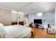 Bright primary bedroom with wooden floors, tiled wall accents, and convenient access to the bathroom at 500 Means Nw St # F, Atlanta, GA 30318