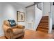 Cozy sitting area features hardwood floors, leather armchair, and staircase access at 500 Means Nw St # F, Atlanta, GA 30318