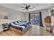 Bright bedroom with hardwood floors, a ceiling fan, a bed, and a sliding door to a balcony with natural light at 702 Hanover Se Ln, Marietta, GA 30067