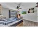 Cozy bedroom featuring hardwood floors, ceiling fan, and a sliding door to a balcony with natural light at 702 Hanover Se Ln, Marietta, GA 30067