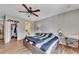 Bedroom with hardwood floors, a ceiling fan, a bed, and a view into the adjoining bathroom and walk-in closet at 702 Hanover Se Ln, Marietta, GA 30067