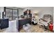 Home office featuring wood floors, a desk, a chair, and a sliding door to a balcony with natural light at 702 Hanover Se Ln, Marietta, GA 30067