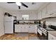 View of the kitchen showcasing updated white cabinets and appliances at 702 Hanover Se Ln, Marietta, GA 30067