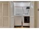 Practical laundry closet with a washer and dryer, featuring white folding doors and neutral decor at 702 Hanover Se Ln, Marietta, GA 30067
