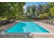 Large community pool surrounded by lounge chairs, offering a recreational space, with lush trees around the area at 1445 Monroe Ne Dr # G7, Atlanta, GA 30324