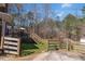 Backyard featuring deck with stairs and a view of wooded area at 1700 Bailey Creek Sw Rd, Conyers, GA 30094