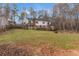 Spacious green backyard featuring a deck and white house at 1700 Bailey Creek Sw Rd, Conyers, GA 30094