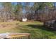 Large, lush backyard offers a firepit area, a storage shed, and ample space for outdoor activities at 1700 Bailey Creek Sw Rd, Conyers, GA 30094