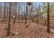 Wooded backyard featuring birdhouses and a wooden fence at 1700 Bailey Creek Sw Rd, Conyers, GA 30094