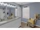 Bright bathroom featuring a double sink vanity with granite countertops and contemporary lighting at 1700 Bailey Creek Sw Rd, Conyers, GA 30094