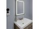 Bathroom features a modern sink with lighted mirror at 1700 Bailey Creek Sw Rd, Conyers, GA 30094