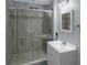 Modern bathroom featuring a glass-enclosed shower with tile walls, contemporary fixtures, and a vanity sink at 1700 Bailey Creek Sw Rd, Conyers, GA 30094