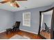 Bright bedroom featuring wood floors, a large mirror, decorative chair, and natural light from the window at 1700 Bailey Creek Sw Rd, Conyers, GA 30094