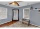 Bright bedroom with a large mirror, wood floors, neutral decor, and natural light from the window at 1700 Bailey Creek Sw Rd, Conyers, GA 30094