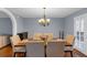 Charming dining room featuring hardwood floors, a modern light fixture, and a six-chair dining table at 1700 Bailey Creek Sw Rd, Conyers, GA 30094