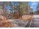 Driveway leading through an opening in wooden fence towards home at 1700 Bailey Creek Sw Rd, Conyers, GA 30094