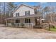 Exterior elevation of the house featuring a large front porch at 1700 Bailey Creek Sw Rd, Conyers, GA 30094