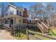 Exterior view of the house with a charming porch, a spacious deck, and an expansive yard at 1700 Bailey Creek Sw Rd, Conyers, GA 30094