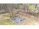 Gravel firepit with plenty of seating and wooden fence at 1700 Bailey Creek Sw Rd, Conyers, GA 30094