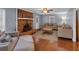 Cozy living room featuring a brick fireplace, ceiling fan, and comfortable couches, creating an inviting space at 1700 Bailey Creek Sw Rd, Conyers, GA 30094