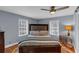 Bedroom featuring a king-size bed, a wooden headboard, and a ceiling fan at 1700 Bailey Creek Sw Rd, Conyers, GA 30094