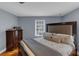 Bedroom featuring a king-size bed, a wooden headboard, and a dresser at 1700 Bailey Creek Sw Rd, Conyers, GA 30094