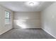 Finished basement with window, neutral walls, and plush gray carpeting offers versatile space at 994 Chapman Cir, Stone Mountain, GA 30088