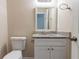 Half bath features a granite countertop vanity and a toilet at 994 Chapman Cir, Stone Mountain, GA 30088